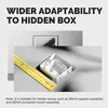 A ruler and two white square boxes are shown in a cut-out in a gray surface, with a framed picture in the background. Produktbild-Vorschau
