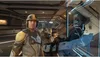 A person in a futuristic suit stands in a spaceship corridor, with a holographic display showing a map. Podgląd zdjęcia produktu