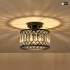 A close-up shot of a black crystal LED ceiling light mounted on a ceiling, casting intricate shadows. Voir les images du produit
