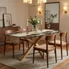 A dining room setting with a glass-top dining table and chairs. Anteprima dell’immagine prodotto