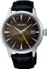 A close-up studio shot of a men's wristwatch with a brown dial and a black leather strap. Produktbild-Vorschau