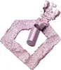 A broken makeup stick lying on a diamond-shaped smear of crushed eyeshadow. Podgląd zdjęcia produktu