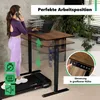 A woman is using a standing desk with a treadmill underneath, working on her laptop and talking on the phone. Produktbild-Vorschau
