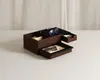 A wooden jewelry box with multiple compartments and drawers, displaying sunglasses, eyeglasses, and other small items. Voir les images du produit