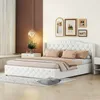 A bedroom scene with a white upholstered bed as the main focus.