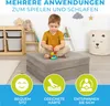 A young boy is playing with building blocks on a folded mat in a child's room. Produktbild-Vorschau