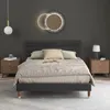 A bedroom scene with a bed, nightstands, and a mirror. Produktbild-Vorschau