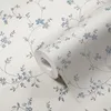 A roll of floral wallpaper with a cream background and blue and gray floral patterns. Produktbild-Vorschau