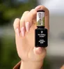 A hand holding a bottle of nail polish. Náhled obrázku produktu
