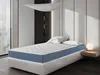 A mattress is displayed on a bed frame in a bedroom setting. Produktbild-Vorschau