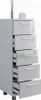 A tall, narrow chest of drawers with a high-gloss white finish, shown against a white background. Some drawers are slightly open, revealing the interior. Decorative items, a diffuser and a candle, are placed on top. Náhled obrázku produktu