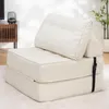 A white foldable sofa bed is shown in a room with a wooden cabinet and a plant in the background. Podgląd zdjęcia produktu