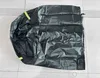 A black pool pump cover laid flat on a tiled floor. Náhled obrázku produktu