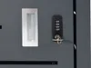 A close-up view of a lock and handle on a dark gray surface. Podgląd zdjęcia produktu