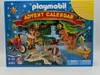 The image shows the front of a Playmobil advent calendar box with a dinosaur theme. Produktbild-Vorschau