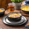 A table setting with various dishes and a drink, suggesting a meal or breakfast. Produktbild-Vorschau
