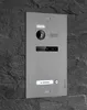 A modern video intercom system mounted on a textured stone wall. Produktbild-Vorschau