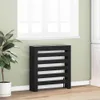 A black radiator cover is placed in a room next to a window and a potted plant. Anteprima dell’immagine prodotto