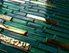 A close-up view of a mosaic tile pattern with alternating green glass tiles and gold metallic tiles. Náhľad obrázku produktu