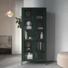 A dark green glass-doored cabinet filled with books and decorative items, placed in a modern living room setting with a pendant light and artwork. Anteprima dell’immagine prodotto