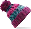 A close-up studio shot of a knitted beanie with a pom-pom. Produktbild-Vorschau