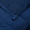 A close-up view of a quilted blue blanket. Náhľad obrázku produktu
