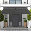 A dark gray awning is installed above a dark gray front door of a modern house. Two potted green plants are placed on either side of the door. Produktbild-Vorschau