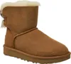 A single brown Ugg boot with a bow detail on the side, shown against a white background. Produktbild-Vorschau