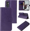 A collage of images showing a purple floral flip phone case from different angles, including its interior card slots and how it can be used as a stand. Produktbild-Vorschau