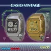 Two Casio vintage watches, one silver and one gold, are displayed against a futuristic grid background with neon accents. Voir les images du produit