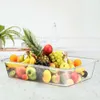 A clear plastic storage container filled with a variety of fresh fruits, placed on a countertop. Náhľad obrázku produktu