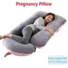 A woman is sleeping on a U-shaped pregnancy pillow. Náhled obrázku produktu