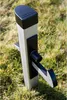 A product for securing a door or gate, standing in grass. Produktbild-Vorschau