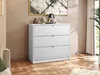 A white dresser with gold handles is shown in a room with a painting on the wall and a plant in the background. Anteprima dell’immagine prodotto