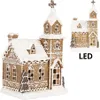 A gingerbread house-style church decoration with snow and LED lights. Anteprima dell’immagine prodotto