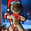 A gingerbread man LED decoration is displayed in a window at night, with a snowy outdoor scene visible through the glass. Produktbild-Vorschau