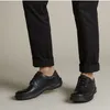 A person wearing black pants and black shoes. Anteprima dell’immagine prodotto