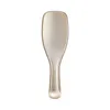 A close-up studio shot of a gold hairbrush against a white background. Anteprima dell’immagine prodotto