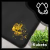 A close-up of a black mat with yellow liquid droplets and a green plant in the background. Náhled obrázku produktu