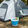 A camping scene with a tent, chair, and a bucket with water and cleaning supplies. Voir les images du produit