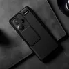 A black phone case with a carbon fiber texture is shown on a dark gray surface. Podgląd zdjęcia produktu