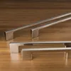 Several cabinet handles are displayed on a wooden surface. Produktbild-Vorschau