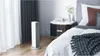 A white Xiaomi Smartmi Fan Heater is placed on a wooden floor next to a bed in a bedroom. Voir les images du produit