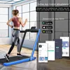 A woman is running on a treadmill in a bright room with large windows. The image also shows app download icons and screenshots of the app. Náhled obrázku produktu