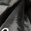 A close-up view of a black tarp, showing its textured surface and a metal grommet. Produktbild-Vorschau
