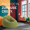 A lime green beanbag chair is placed in a stylishly decorated room with colorful walls and a large window. Anteprima dell’immagine prodotto