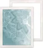 Two white picture frames are shown, one in front of the other. The front frame displays a teal background with a white mandala pattern. Produktbild-Vorschau