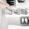 A hand is reaching into a kitchen drawer to pick up cutlery from a drawer organizer. Anteprima dell’immagine prodotto