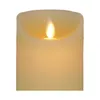 A close-up view of the top of a cream-colored LED candle with a flickering LED flame. Anteprima dell’immagine prodotto