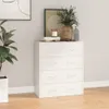 A white dresser with four drawers is shown in a room with a plant and artwork. Podgląd zdjęcia produktu